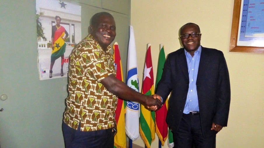 Photo - Mr Dedi (left) welcomes Mr Dadzie to the office with souvenirs of the FCWC