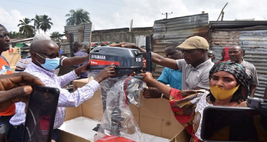West Point Liberian Fishermen Cooperative Limited receiving five boxes of the Yamaha outboard engines from Hon. William Y. Boeh , Deputy Director General for Technical Services (Left-Right)