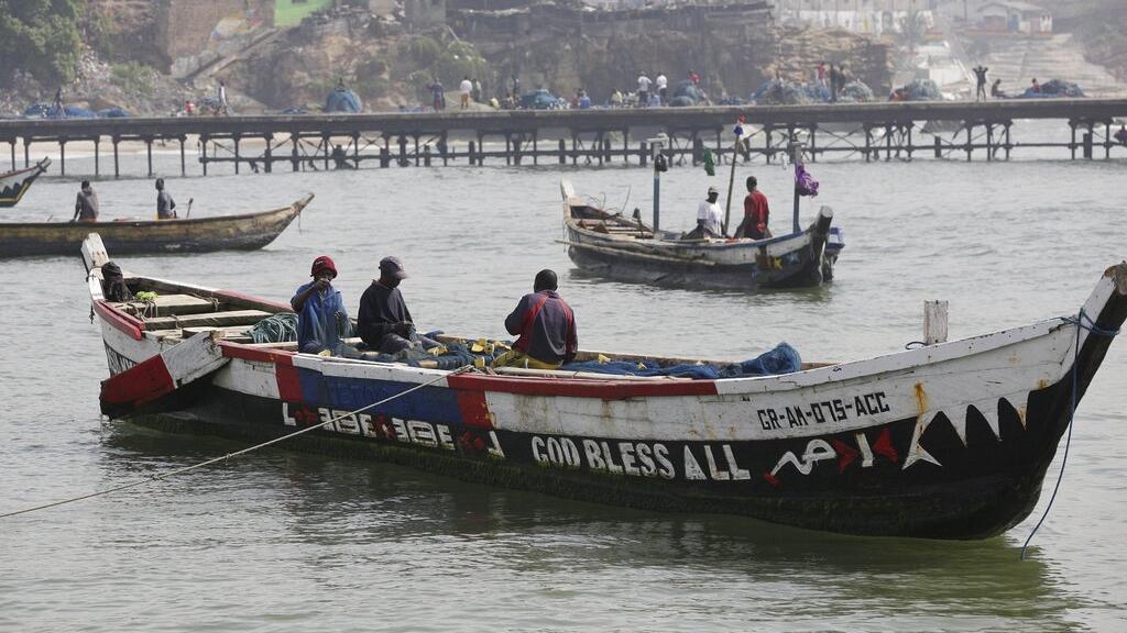 Ghana boats on water fishermen inside
