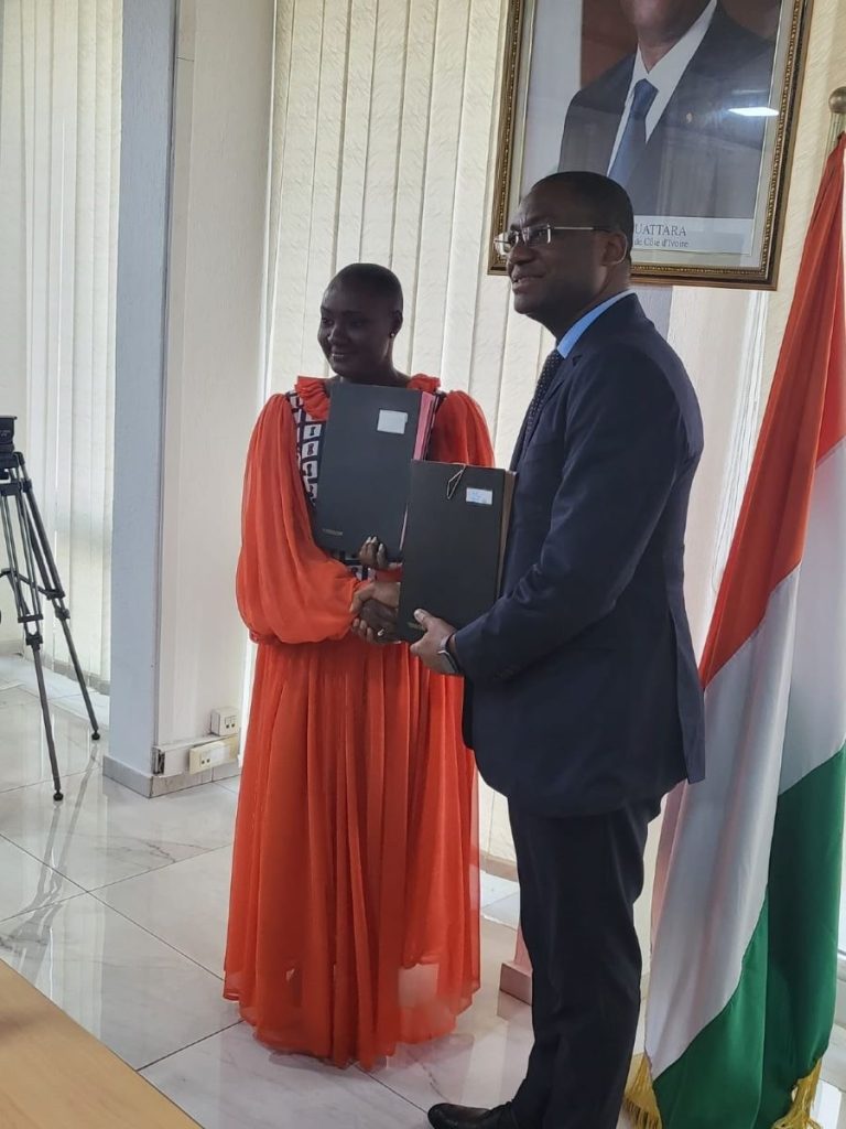 DG Glassco of Liberia and Hon. Toure of displaying the MoU following the signing ceremony Cote D’Ivoire